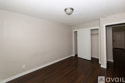 A room with wooden floors and white walls.