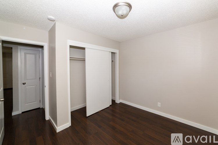 A room with a white door and a white closet.