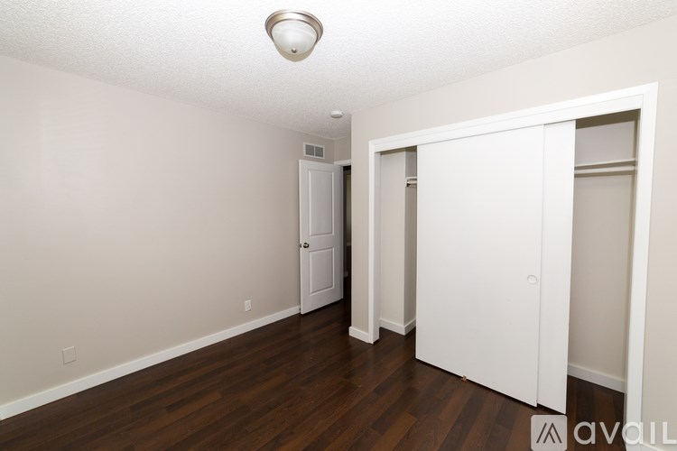 A room with a white door and a white closet.