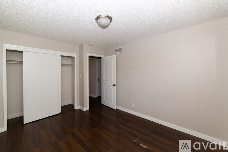 A room with a wooden floor and white walls.