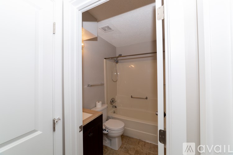 A bathroom with a toilet, sink, and bathtub.