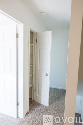 A white door is open to a hallway.