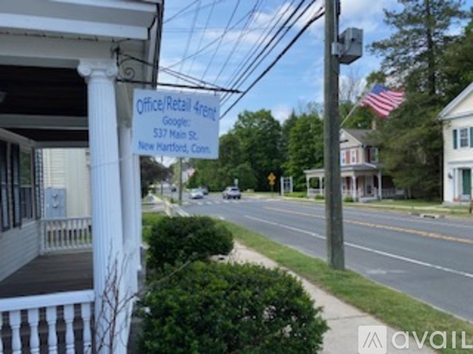 A street view with a sign for an office/retail space at 537 Main St, New Martford, Conn.