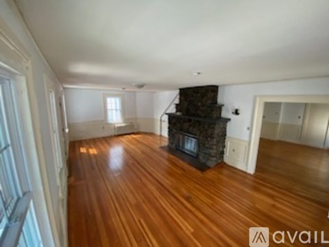 A living room with a fireplace and hardwood floors.