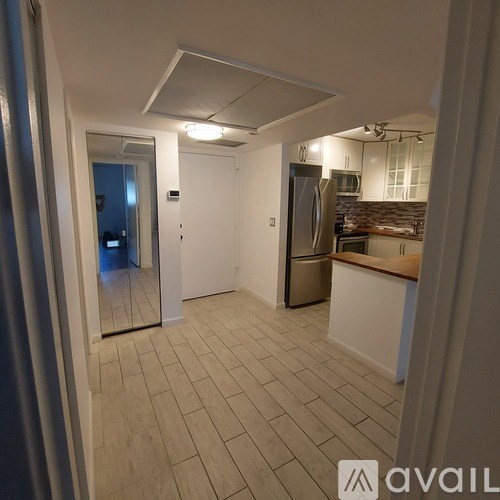 A room with a ceiling fan and wooden flooring.