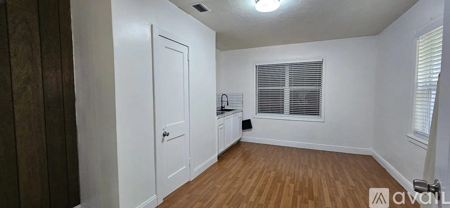 A room with wooden floors and white walls.
