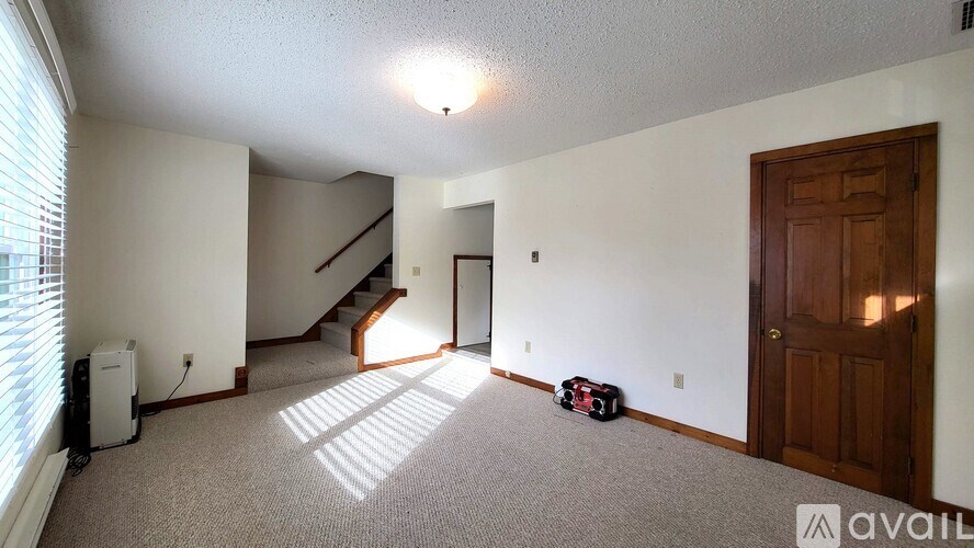 A room with a staircase and a door.