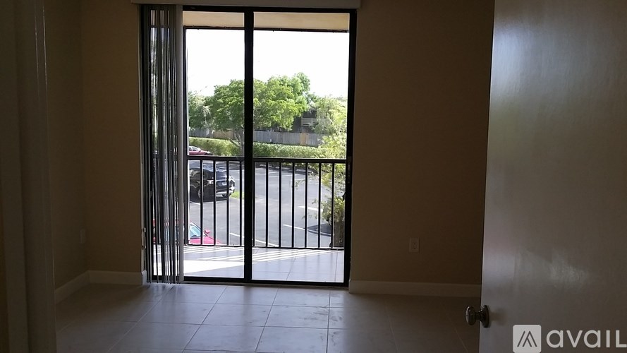 A room with a sliding glass door leading to a balcony.