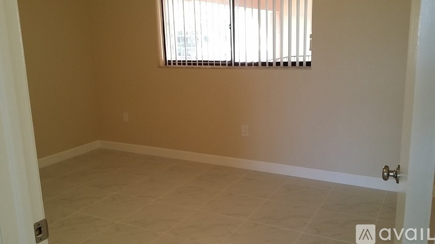 A room with beige walls and a tiled floor.