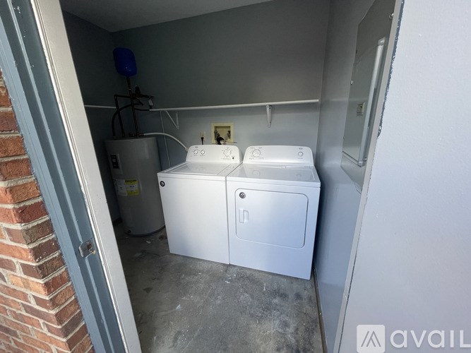 A small utility room with a washer and dryer.