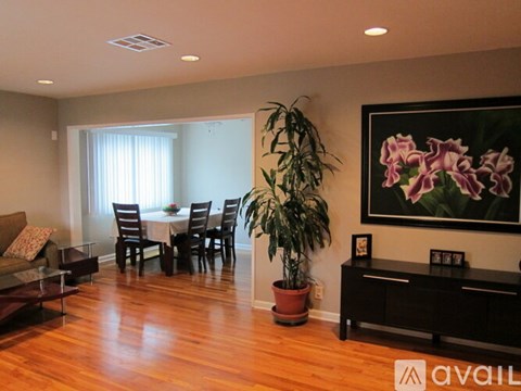 A living room with a dining table and chairs.