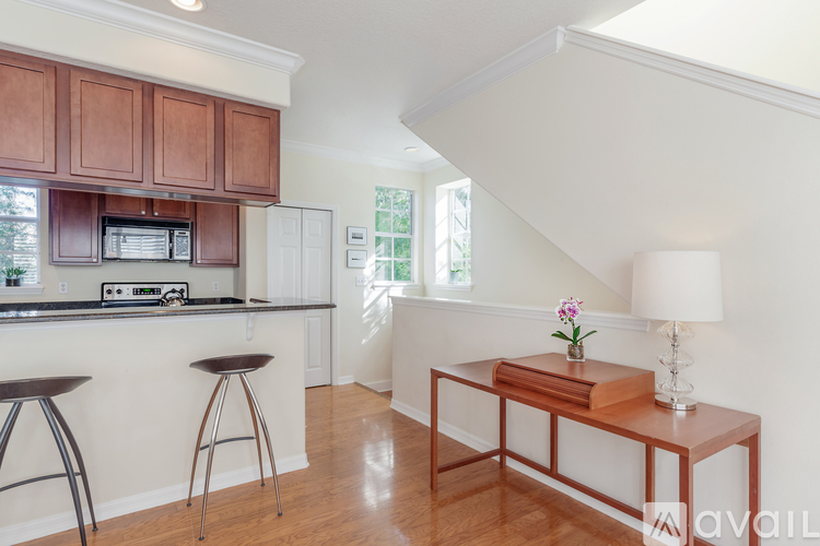 A kitchen with brown cabinets and a white countertop.