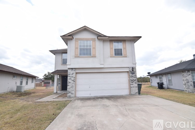 A two-story house with a garage is available for sale.