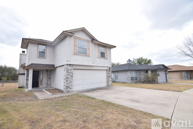 A two-story house with a garage is available for rent.