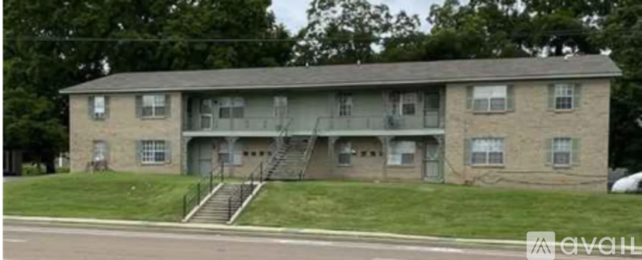 A two-story apartment building with a staircase leading to the second floor.