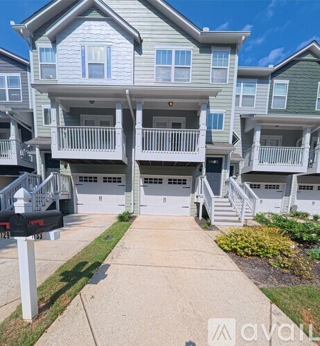 A row of townhouses with a mailbox in front.