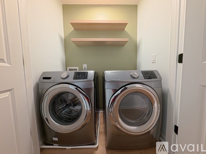 Two front load washing machines in a laundry room.