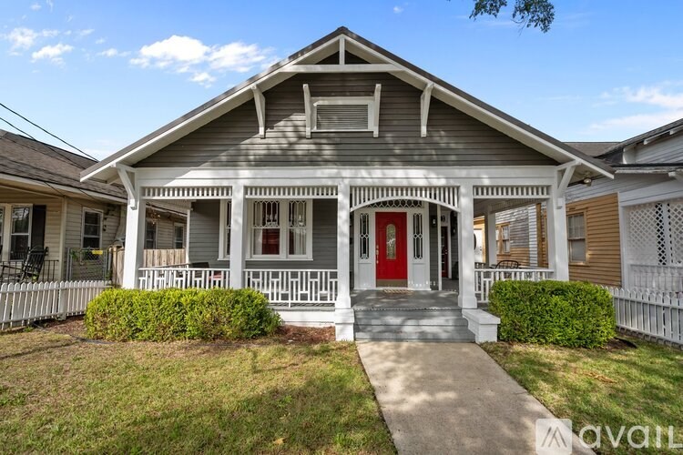 A house with a red door and a porch.