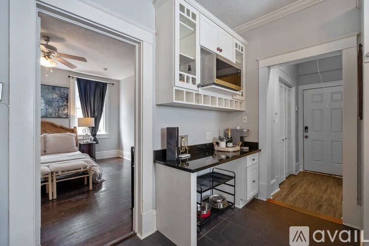 A kitchen with a white cabinet and black countertop is shown.
