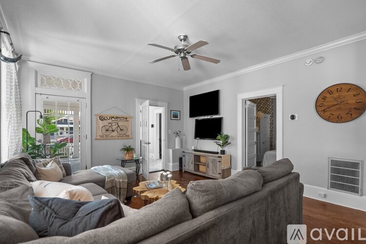 A living room with a grey couch and a wooden coffee table.