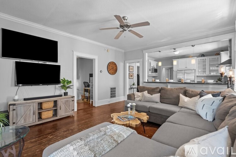 A living room with a grey couch and a wooden coffee table.