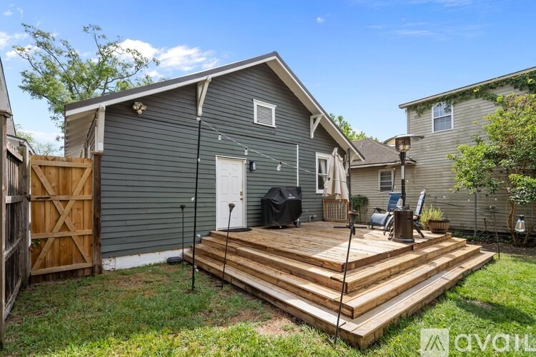 A house with a grey exterior and a wooden deck.