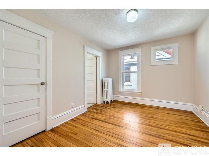 A room with wooden floors and a white door.