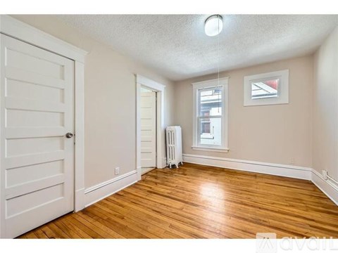 A room with wooden floors and a white door.