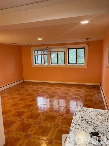 A room with orange walls and a tiled floor.