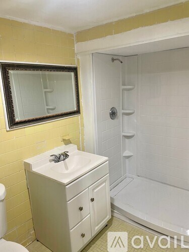 A bathroom with a sink, toilet, and shower.