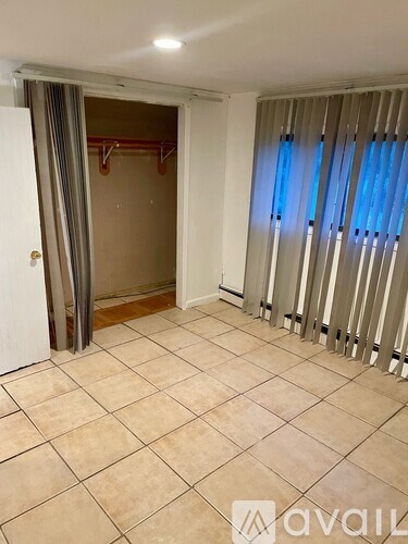 A room with a tiled floor and a sliding door.