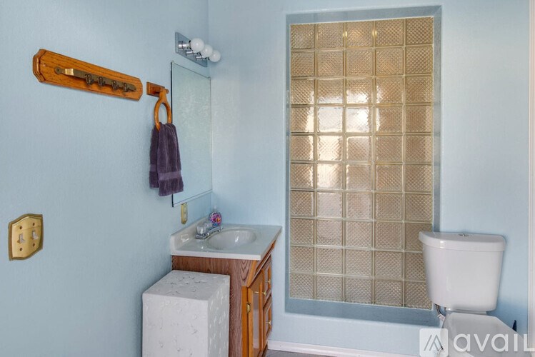 A bathroom with a white toilet and a sink.