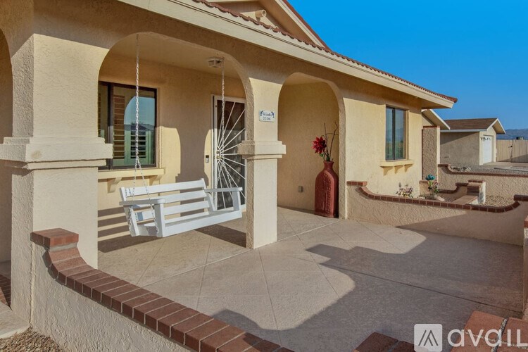 A house with a red door and a white porch swing.
