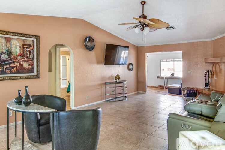 A living room with a table and chairs.