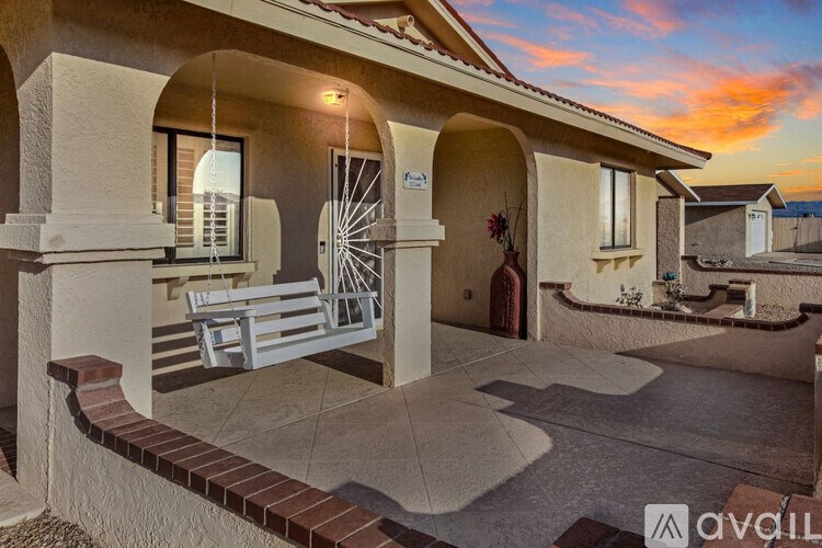 A house with a white door and a bench outside.