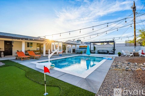 A red flag is stuck in the ground near a pool.