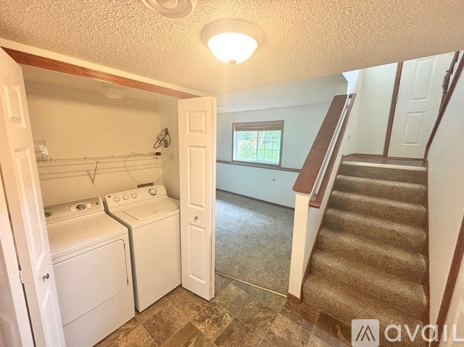 A laundry room with a washer and dryer in it.