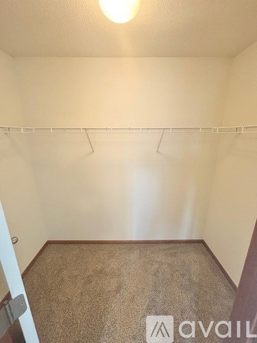 A room with a carpeted floor and a white wall.