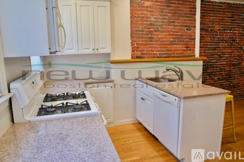 A kitchen with a white stove and cabinets.