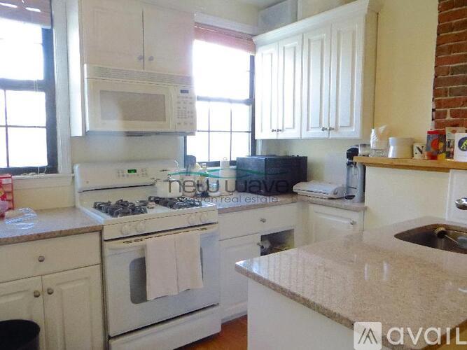 A kitchen with white appliances and cabinets.