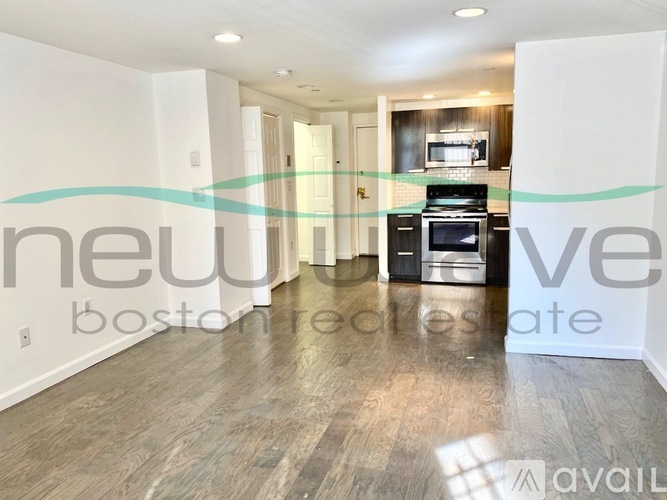 A spacious living room with a kitchen in the background and a sign that says "new boston residential".