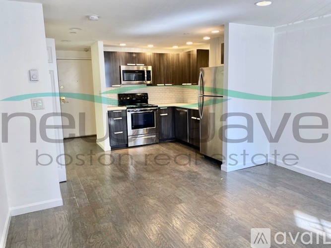 A kitchen with a stove top oven and a refrigerator.