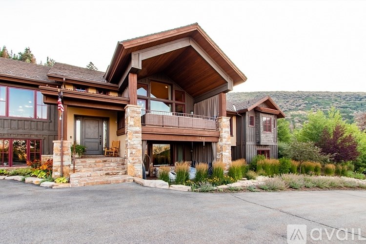 A house with a balcony and a flag on the front porch.