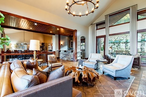 A living room with a brown leather couch and a wooden coffee table.