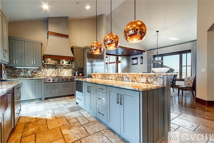 A kitchen with a marble countertop and a tile floor.
