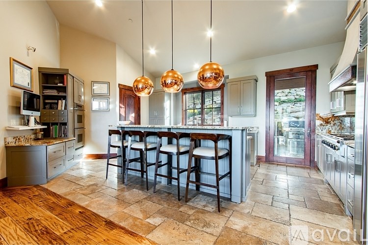 A kitchen with a bar area and a tiled floor.