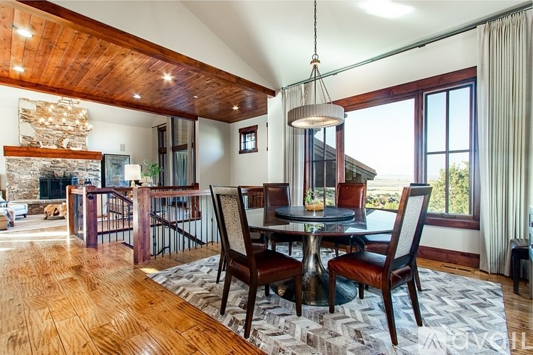 A modern dining room with a wooden table and chairs.