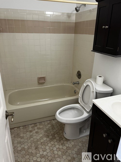A bathroom with a toilet, sink, and bathtub.
