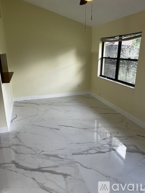 A room with marble flooring and a window.
