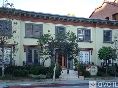 A two-story house with a red awning and a sign that says "AVAILABLE".